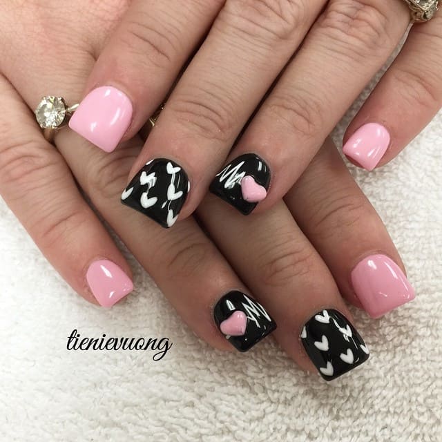 Some white and pink hearts may sit perfectly on pink and black nail polish