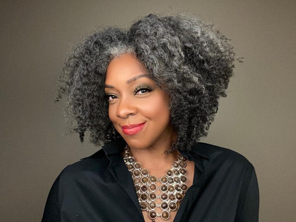 black woman with short gray curly hair