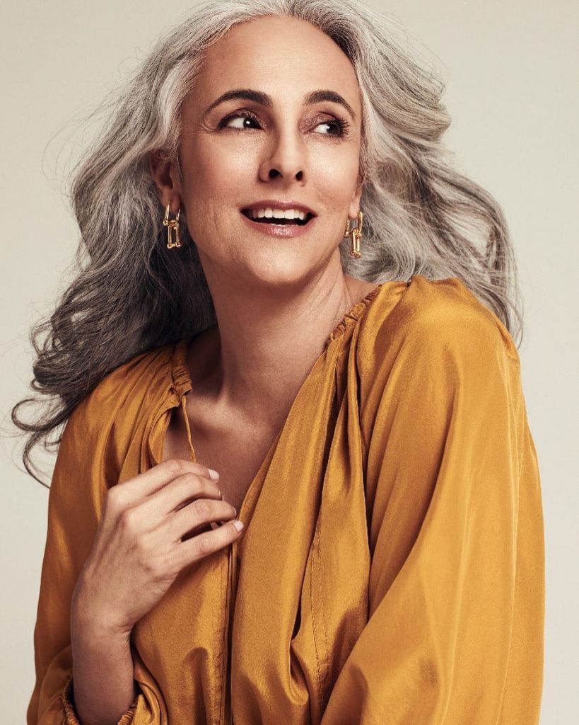 woman wearing IT hair color with beige shirt