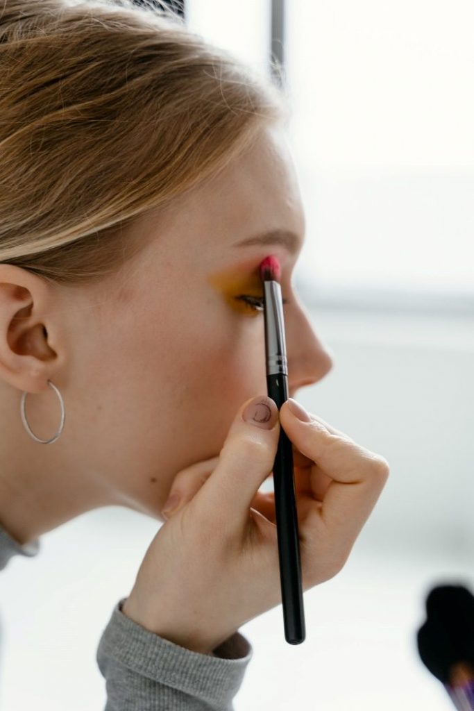 A woman applying basic makeup for beginners