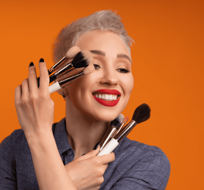 makeup artist holding makeup brushing